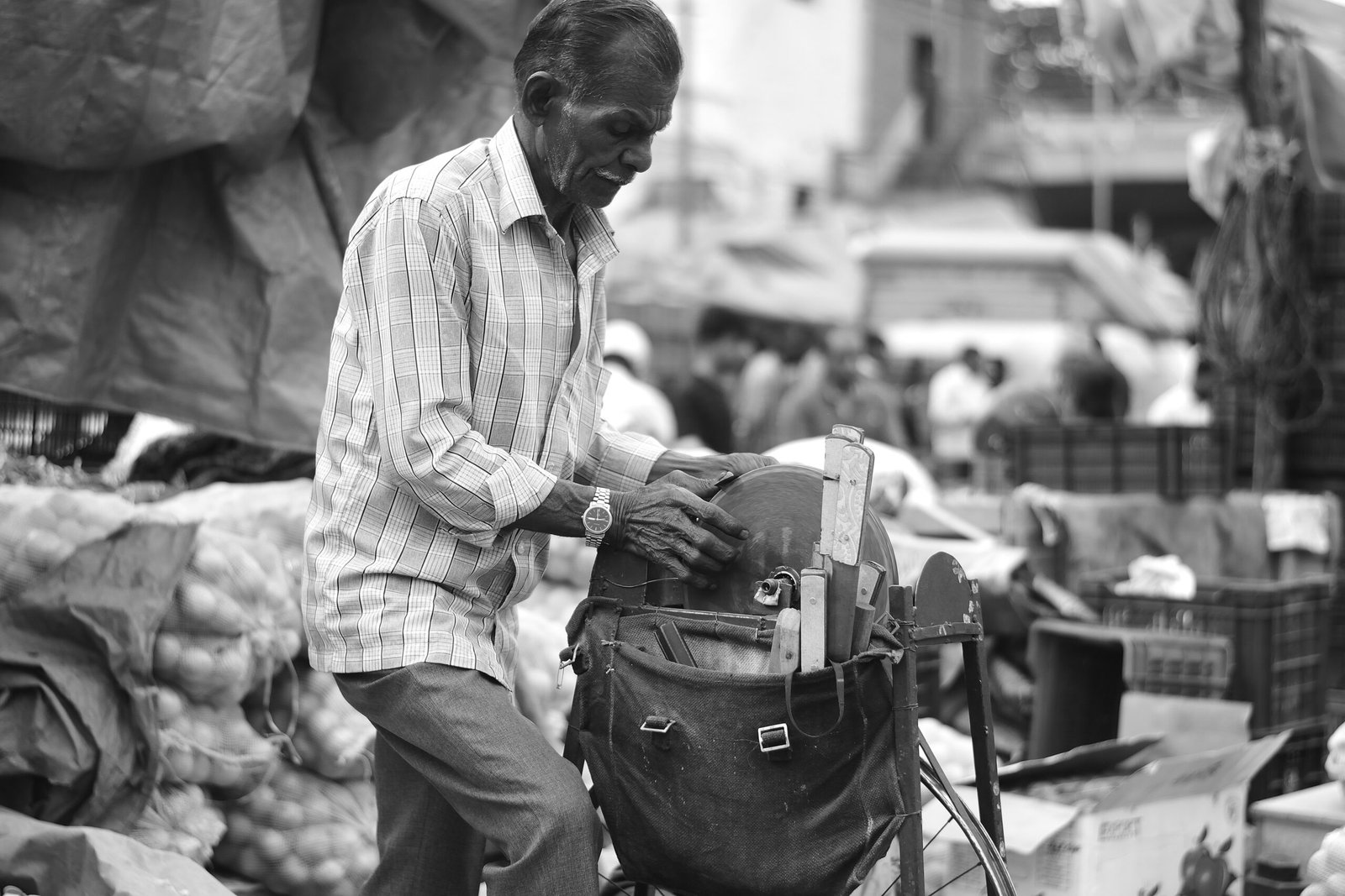 A black and white photo of a man on a bicycle